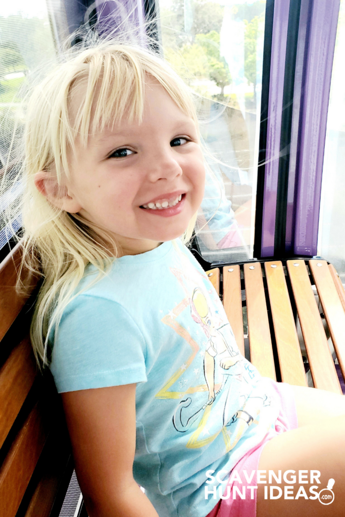 child smiling while riding disney skyliner